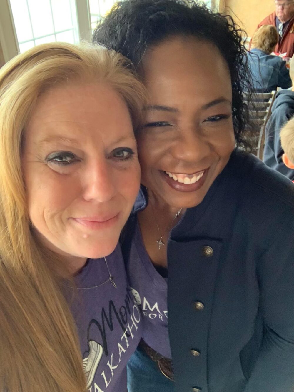 Two Moms for America members embracing at an event